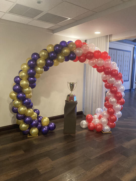 The Cup under the balloon arch